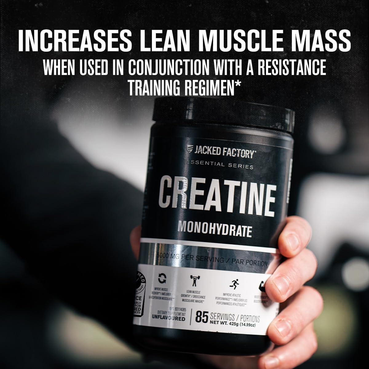 Jacked Factory Creatine Monohydrate supplement container held by a hand with promotional text on a blurred background