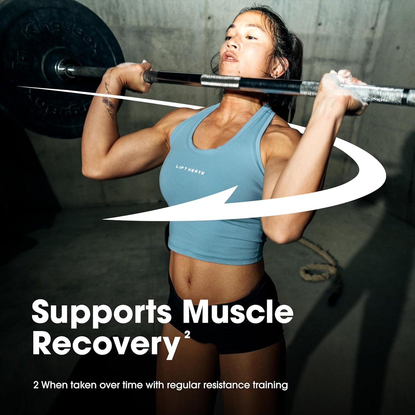 Person lifting weights with a product label for muscle recovery support.